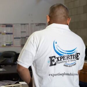 Professional kitchen plumbing service fixing a clogged sink