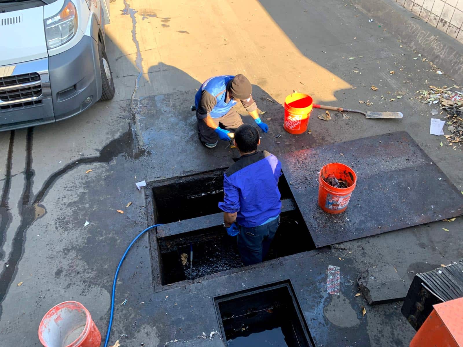 Professional plumber performing drain cleaning on residential property
