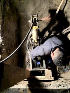 Plumber inspecting sewer line during trenchless repair service