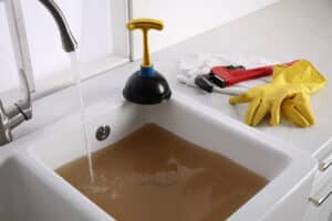 Clogged Sink With Dirty Water And Plunger