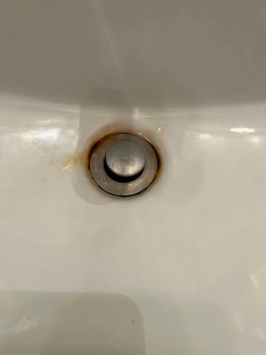 kitchen sink drain with visible buildup around the edges