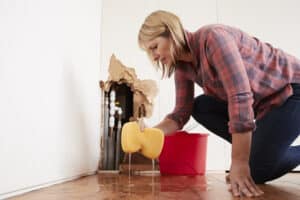 Woman Cleaning up Water Damage in Home