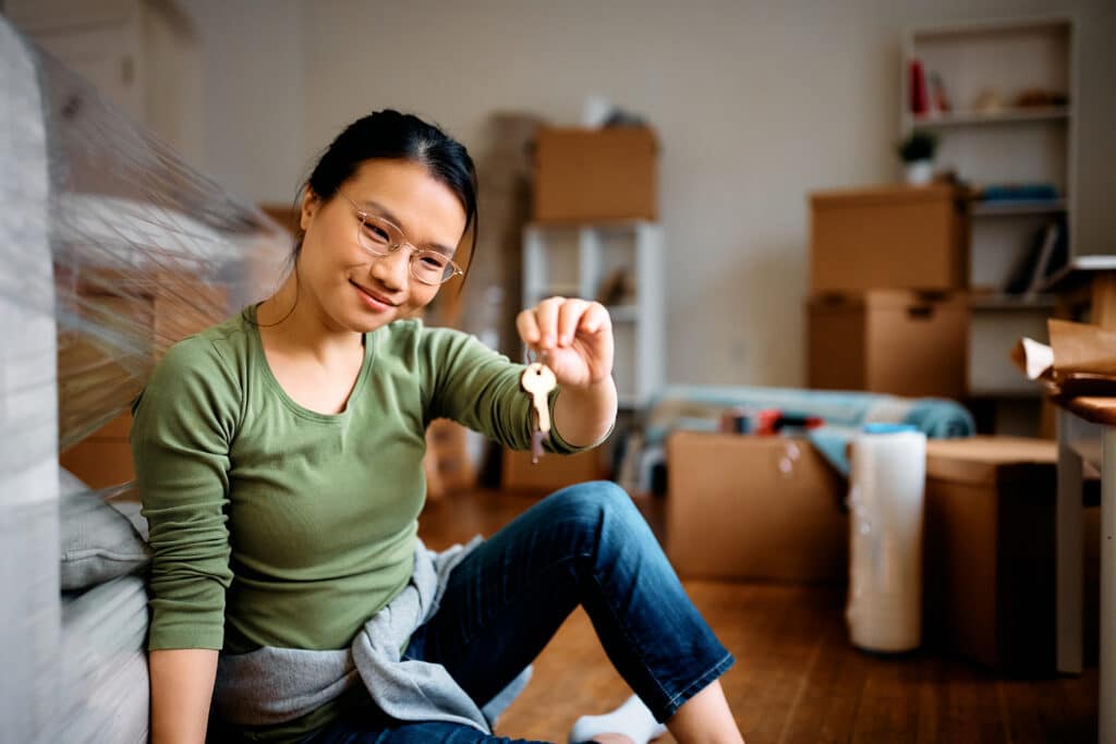 Young Woman Holds Keys in New Home